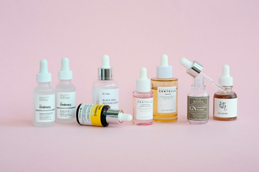 Korean skincare products arranged on a pink background, illustrating an Anua skincare review