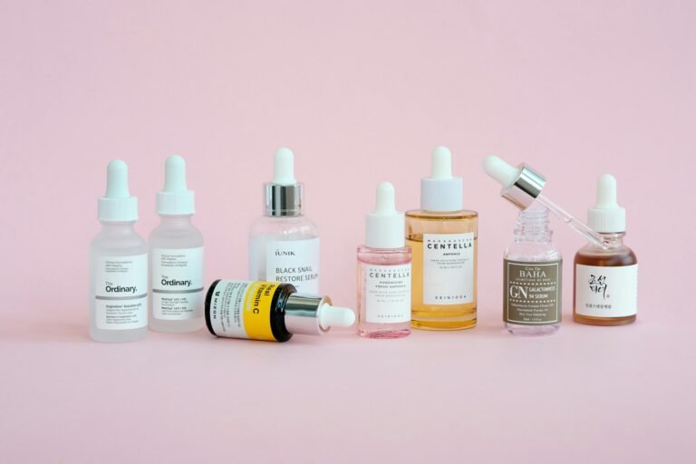 Korean skincare products arranged on a pink background, illustrating an Anua skincare review