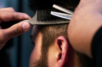 Barber trimming a man’s thinning hair, illustrating hair loss treatment options for men