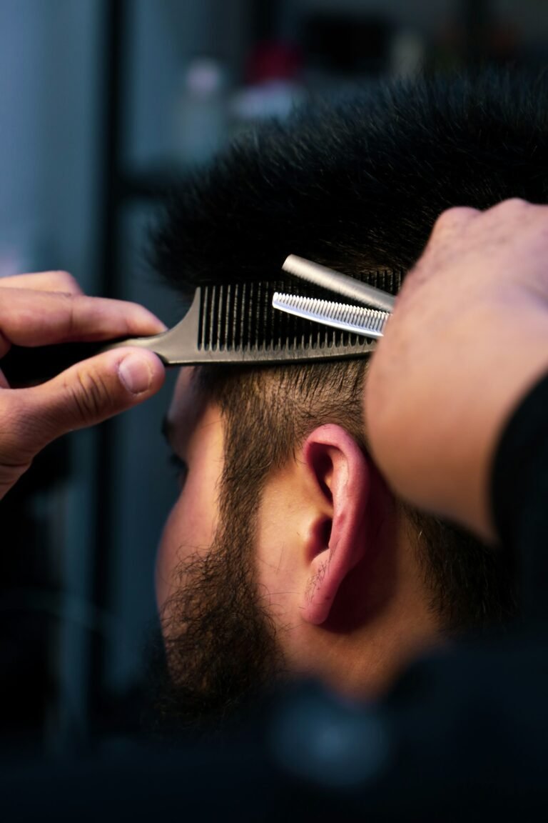 Best Hair Loss Treatment for Men: Reviews and Options Compared 12 Barber trimming a man’s thinning hair, illustrating hair loss treatment options for men